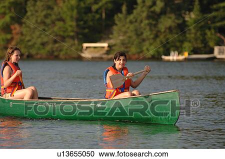 Two people in a canoe View Large Photo Image Stock Image - Two people in a canoe. Fotosearch