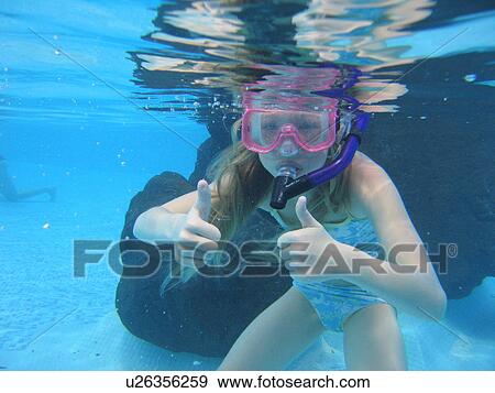 Underwater view of a young girl (12-13) swimming wearing scuba gear, Moorea, Tahiti, French Polynesia, South Pacific View Large Photo Image Stock Photo - Underwater view of a young girl (12-13) swimming wearing scuba gear, Moorea, Tahiti, French Polynesia, South Pacific. Fotosearch