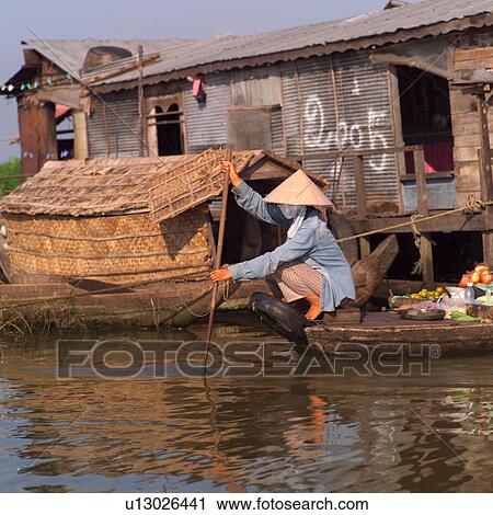 Asian woman paddling a boat View Large Photo Image Stock Image - Asian woman paddling a boat. Fotosearch