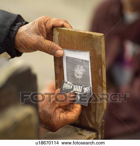 Close-up of a person holding a photograph and a wooden frame, Havana, Cuba View Large Photo Image Picture - Close-up of a person holding a photograph and a wooden frame, Havana, Cuba. Fotosearch