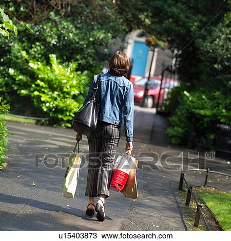 Dublin, Ireland – Brunette walking carrying packages View Large Photo Image Stock Image - Dublin, Ireland – Brunette walking carrying packages. Fotosearch