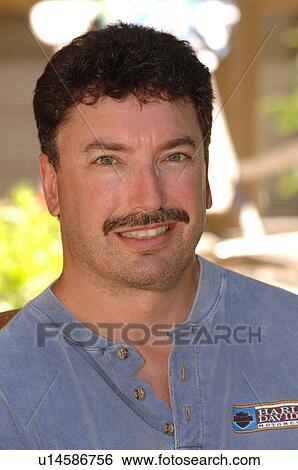 Stock Photograph - Man with moustashe looking at camera. Fotosearch