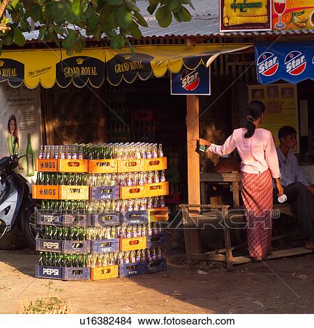 Picture - Pile of crated bottles at a street side market. Fotosearch