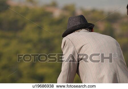 Stock Photo - Rear view of a man leaning forward in Athens, Greece. Fotosearch