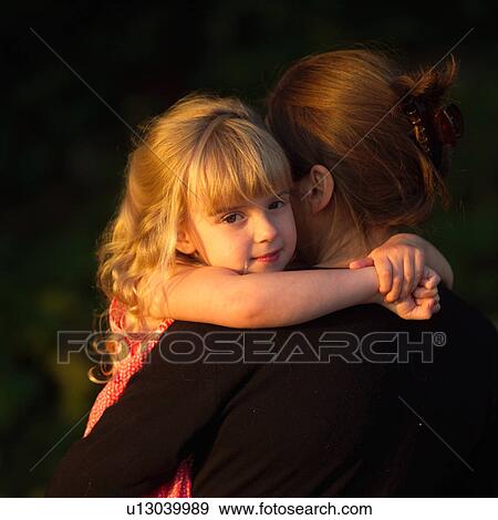 Stock Photo - 4 year old embracing her Mother's neck. Fotosearch