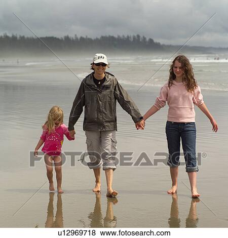 Adult walking with children on beach View Large Photo Image Stock Photo - Adult walking with children on beach. Fotosearch