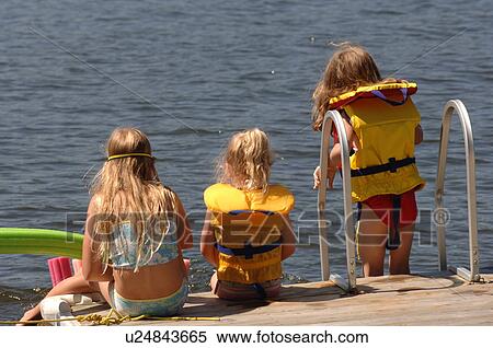 Children at edge of dock wearing lifejackets View Large Photo Image Stock Photography - Children at edge of dock wearing lifejackets. Fotosearch