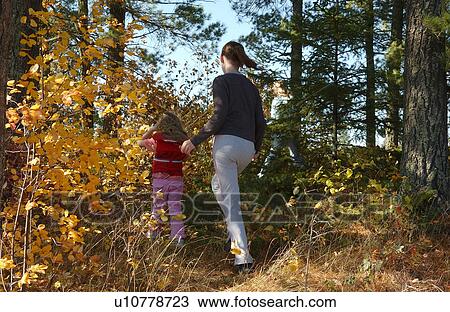 Stock Image - Children walking in Forest. Fotosearch