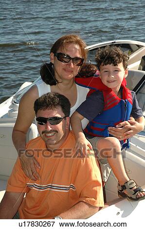Mother, father and son on a boat View Large Photo Image Stock Photo - Mother, father and son on a boat. Fotosearch