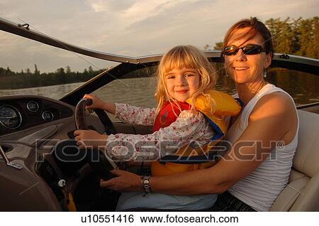 Mother holding child in a boat View Large Photo Image Stock Photograph - Mother holding child in a boat. Fotosearch