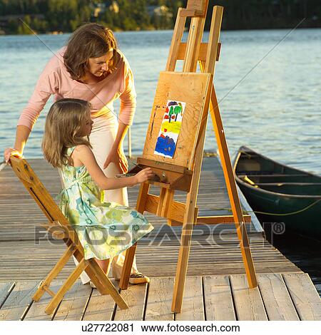 Mother looking at child's artwork View Large Photo Image Stock Image - Mother looking at child's artwork. Fotosearch