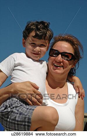 Mother with arm around son View Large Photo Image Picture - Mother with arm around son. Fotosearch