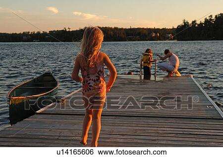 People on a dock at twilight View Large Photo Image Stock Photograph - People on a dock at twilight. Fotosearch