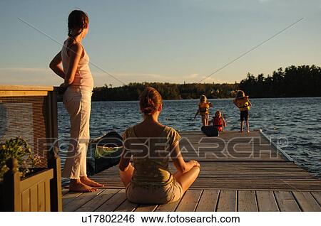 People on a dock at twilight View Large Photo Image Stock Photograph - People on a dock at twilight. Fotosearch