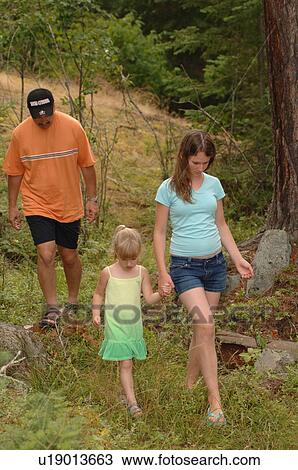 People walking along path in forest View Large Photo Image Stock Image - People walking along path in forest. Fotosearch