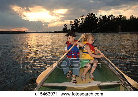 Two four year olds holding oars in a boat View Large Photo Image Stock Image - Two four year olds holding oars in a boat. Fotosearch