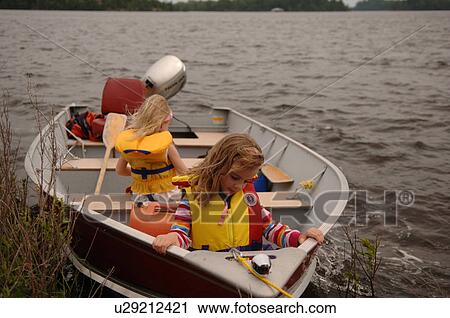 Stock Image - Two small children along in a motorboat. Fotosearch
