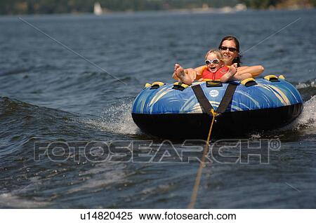 Stock Photography - Woman and 4 year old in raft on Lake of the Woods. Fotosearch