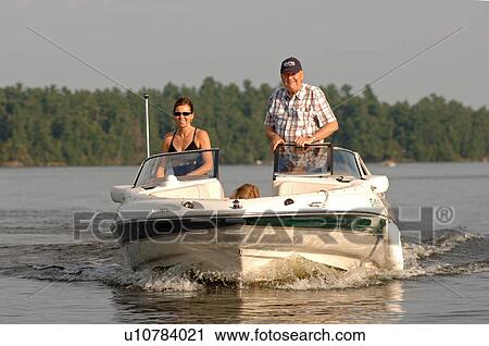 Woman and man standing in a boat View Large Photo Image Stock Image - Woman and man standing in a boat. Fotosearch
