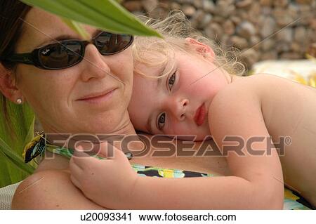 Close-up of a young mother holding her daughter View Large Photo Image Stock Image - Close-up of a young mother holding her daughter. Fotosearch