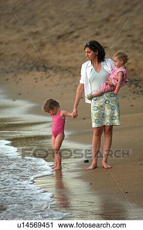 Stock Image - Family on Beach - Hawaii. Fotosearch