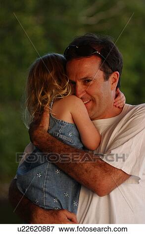 Stock Photo - Father hugging his daughter. Fotosearch