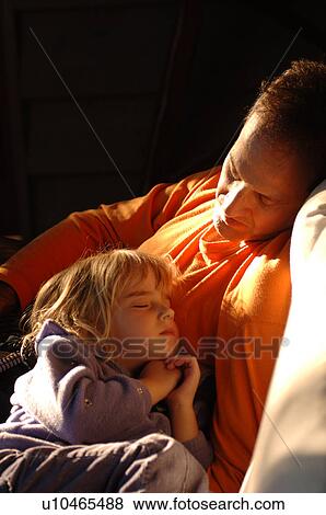 Father looking at his sleeping daughter View Large Photo Image Stock Photo - Father looking at his sleeping daughter. Fotosearch