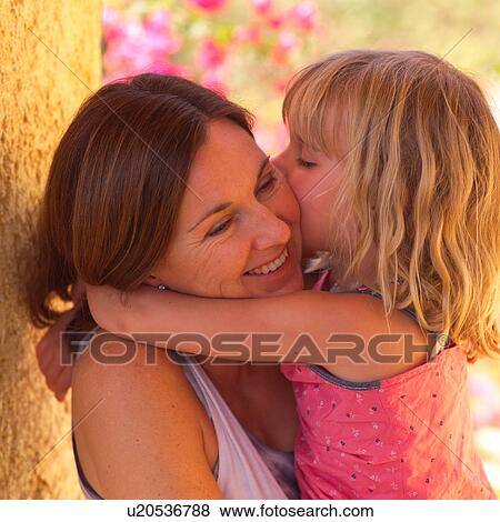 Stock Photo - Mother cuddling with her daugher. Fotosearch