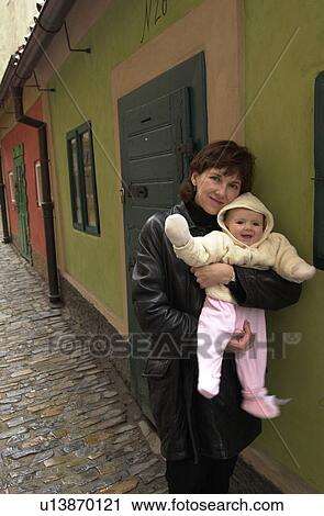 Stock Image - Portrait of woman holding baby. Fotosearch