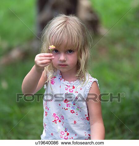 Blond Child Holding Flower Up to Camera at Moorea in Tahiti View Large Photo Image Stock Photograph - Blond Child Holding Flower Up to Camera at Moorea in Tahiti. Fotosearch