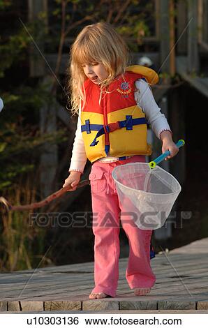 Blond child in lifejacket holding a net View Large Photo Image Stock Photograph - Blond child in lifejacket holding a net. Fotosearch