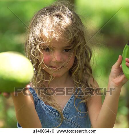 Stock Image - Blond Child with Hair in Face. Fotosearch