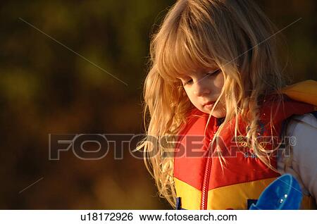 Blond girl wearing a lifejacket View Large Photo Image Stock Photograph - Blond girl wearing a lifejacket. Fotosearch