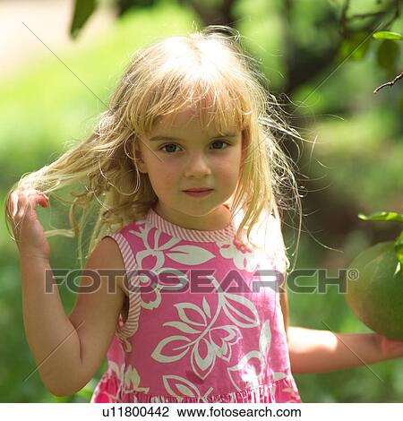 Stock Image - Blond Girl with Fingers in Hair. Fotosearch