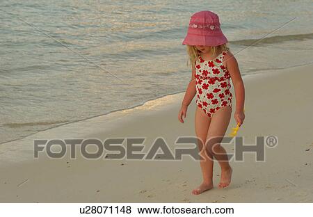 Close-up of a young girl (6-8) on a beach View Large Photo Image Stock Photo - Close-up of a young girl (6-8) on a beach. Fotosearch