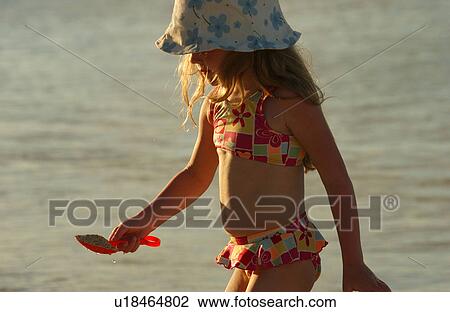 Close-up of a young girl on a beach View Large Photo Image Stock Image - Close-up of a young girl on a beach. Fotosearch