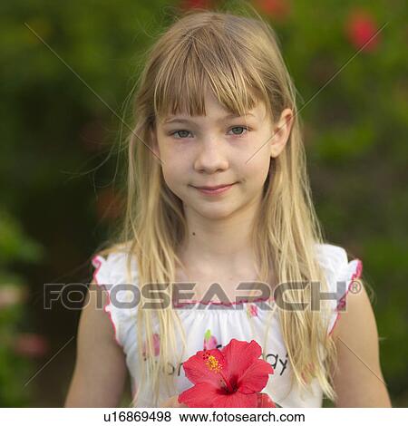 Stock Photo - Girl Holding Tropical Flower. Fotosearch