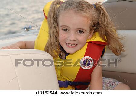 Girl wearing a lifejacket View Large Photo Image Picture - Girl wearing a lifejacket. Fotosearch