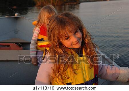 Girl with yellow lifejacket on View Large Photo Image Stock Photograph - Girl with yellow lifejacket on. Fotosearch