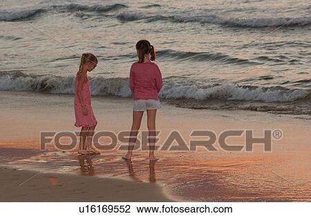 Stock Image - Kids playing on beach - Hawaii. Fotosearch