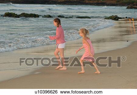 Stock Photograph - Kids playing on beach - Hawaii. Fotosearch
