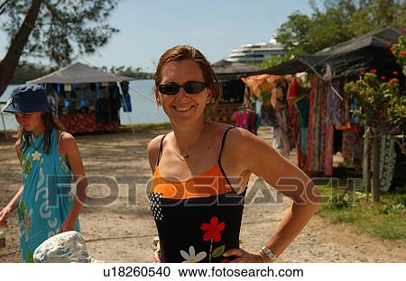 Stock Image - Portrait of a young woman on a beach. Fotosearch