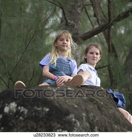 Sisters Sitting on a Rock View Large Photo Image Stock Image - Sisters Sitting on a Rock. Fotosearch