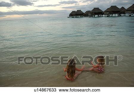 Two young girls( 6-8) playing on a beach View Large Photo Image Stock Image - Two young girls( 6-8) playing on a beach. Fotosearch