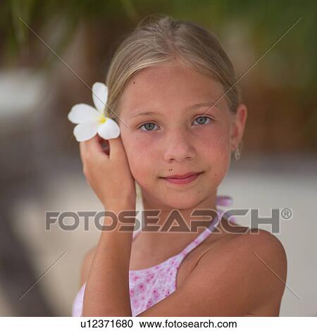 Young Girl Holding White Flower in Her Hair View Large Photo Image Stock Image - Young Girl Holding White Flower in Her Hair. Fotosearch