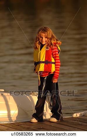 Stock Photography - Young girl in life jacket. Fotosearch