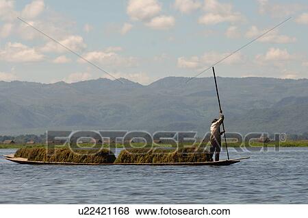 Farmers in row boat View Large Photo Image Stock Photo - Farmers in row boat. Fotosearch