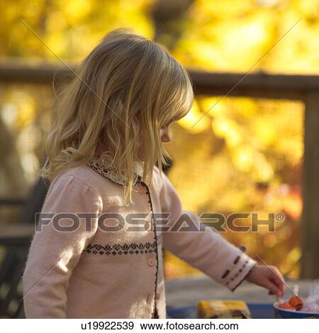 Stock Photo - Blond Girl in Pink Sweater. Fotosearch