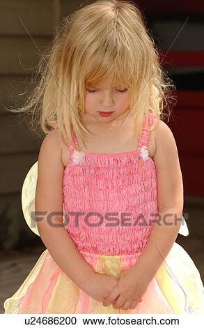 Close-up of a young girl looking down wearing a fairy costume View Large Photo Image Stock Image - Close-up of a young girl looking down wearing a fairy costume. Fotosearch