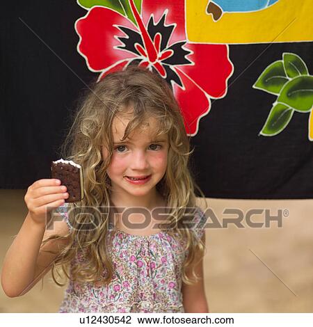 Stock Image - Girl Holding Up Ice Cream Bar. Fotosearch